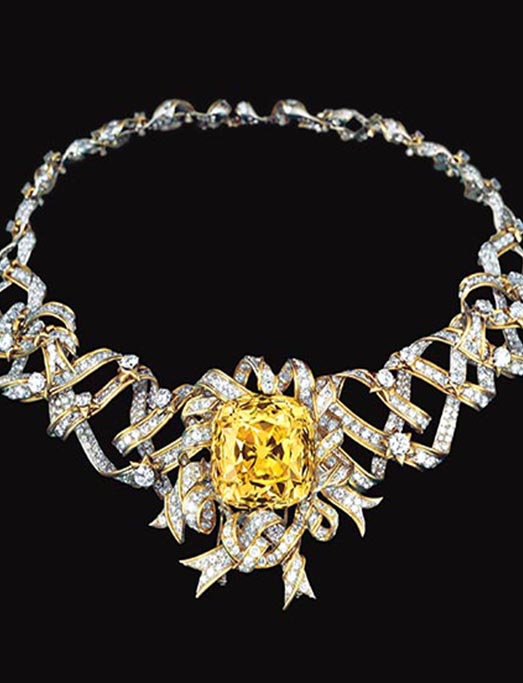 Tiffany's emerald cut yellow diamond in a ribbon diamond necklace in the publicity shoot for "Breakfast at Tiffany's"