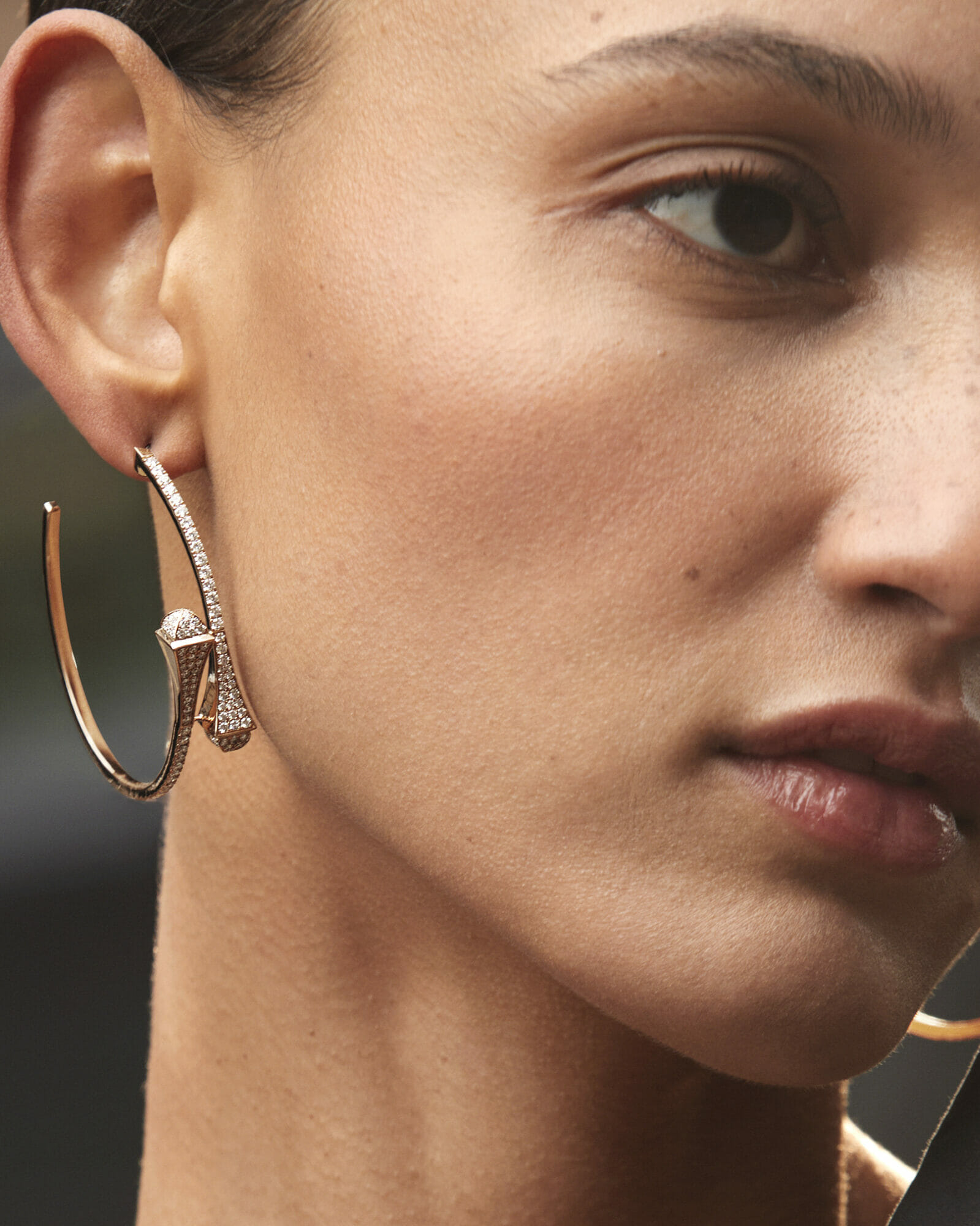 New hoops, woman wearing double diamond hoop earrings closeup